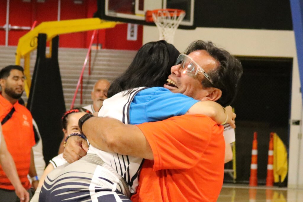 2024 Summer Games athlete and coach hug