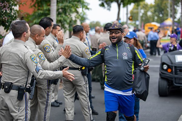 LETR giving athletes high-fives at 2026 Summer Games